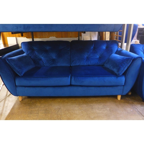 1556 - A pair of blue Hoxton velvet three seater sofas and arm chair