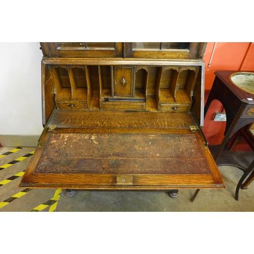 19 - An early 20th Century Jacobean Revival oak bureau bookcase