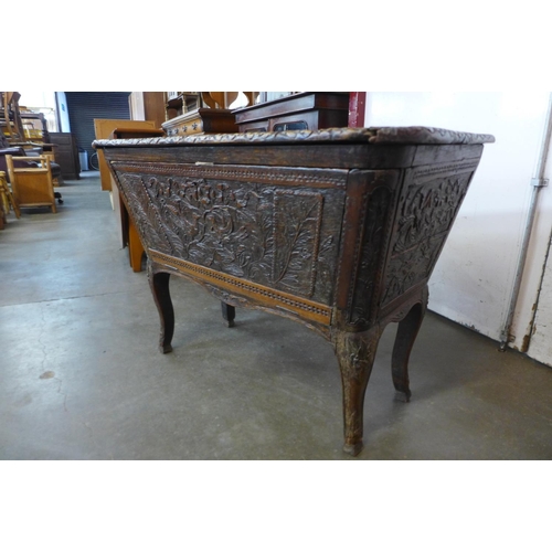 113 - An unusual extensively carved 19th Century French oak sarcophagus shaped coffer