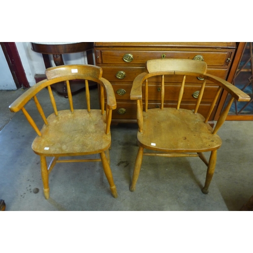 181 - A pair of similar elm and beech smokers bow chairs