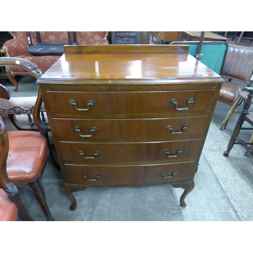 212 - A walnut bow front chest of drawers