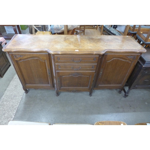 215 - A large French carved oak breakfront sideboard