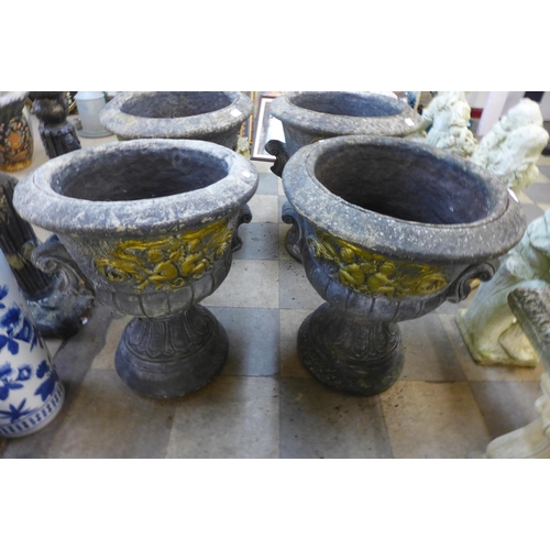 271 - A pair of concrete campana shaped garden urns on stands