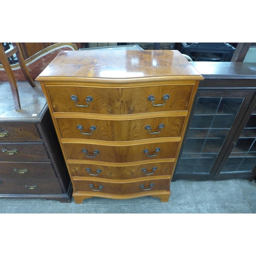 106 - A yew wood serpentine chest of drawers