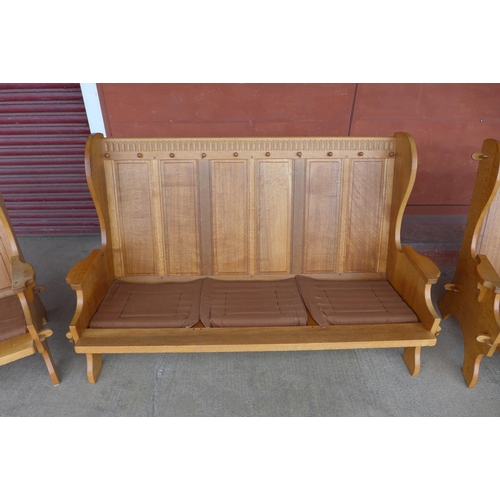 120A - A Nigel Griffiths Monastic oak three piece lounge suite, comprising; sette and a pair of armchairs