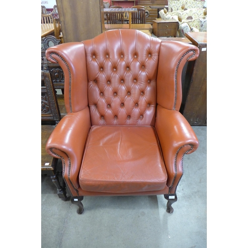 136 - A red leather Chesterfield wingback armchair