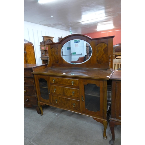 174 - An early 20th Century figured walnut mirrorback sideboard