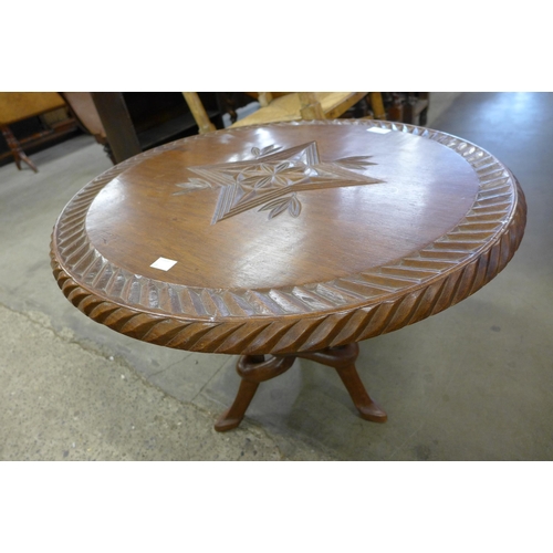 180 - An African hardwood circular occasional table