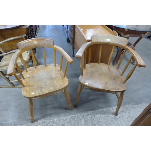 181 - A pair of similar elm and beech smokers bow chairs