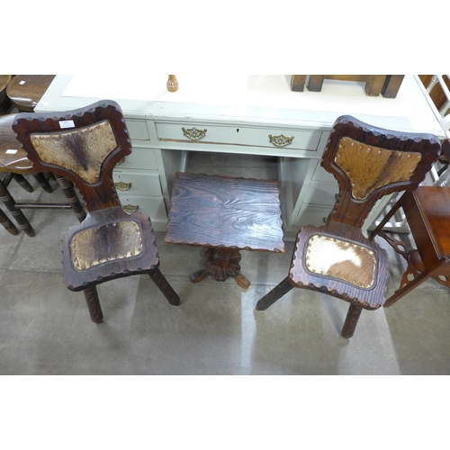 191 - A pair of Spanish carved pine chairs and matching occasional table