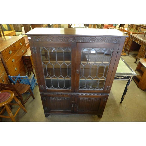 201 - A carved oak linenfold four door bookcase