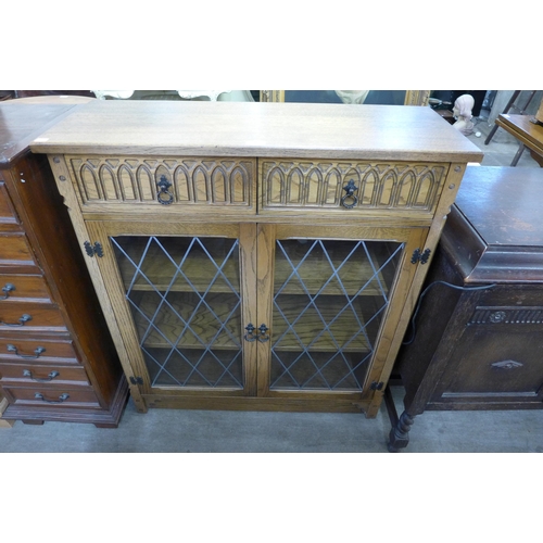 208 - A carved oak two door bookcase