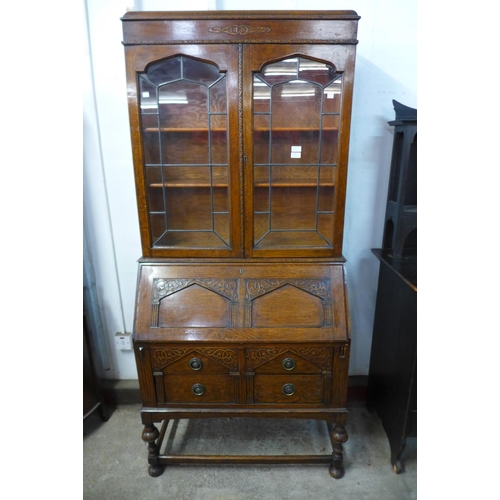 229 - An early 20th Century carved oak bureau bookcase