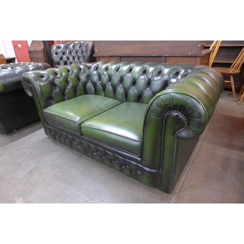 24 - A green leather Chesterfield settee