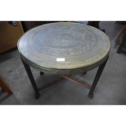 243 - An Islamic brass topped occasional table