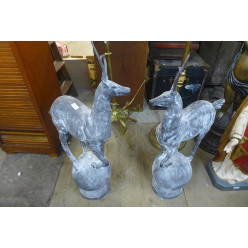 265 - A pair of cast iron garden figures of stags