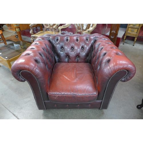 27 - An oxblood red leather Chesterfield club chair