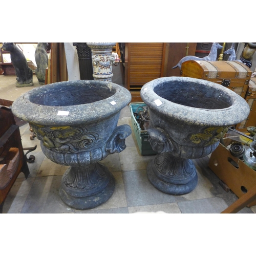 271 - A pair of concrete campana shaped garden urns on stands