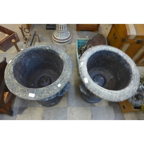 271 - A pair of concrete campana shaped garden urns on stands