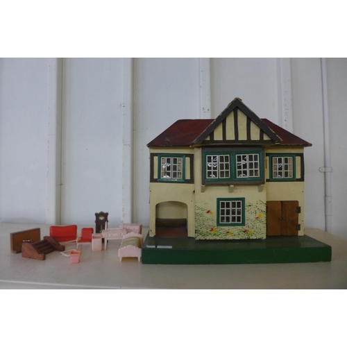 272 - A vintage child's Tri-ang dolls house with accessories