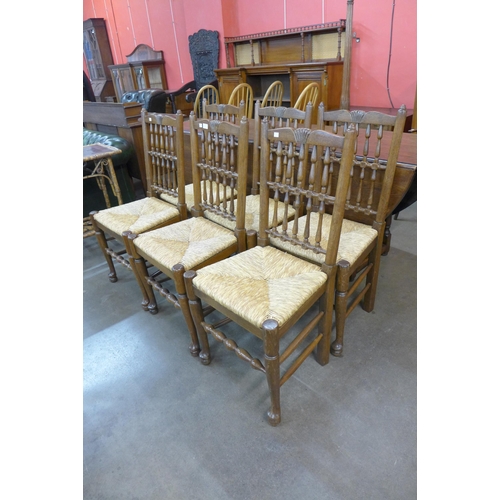 29 - A set of six George III style elm and rush seated spindle back chairs