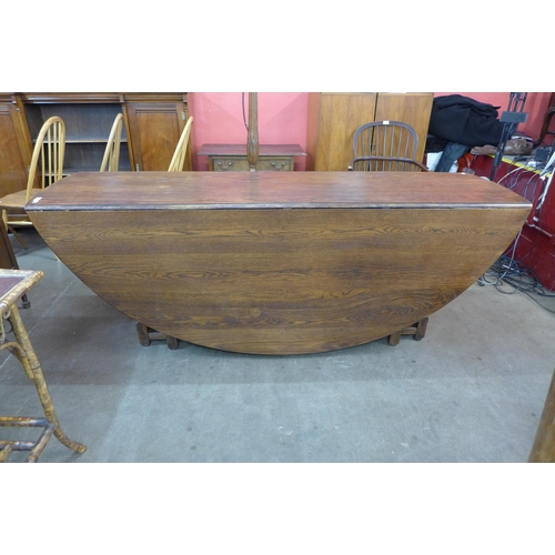 30 - A large George III style oak gateleg wake table