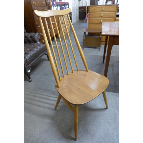 33 - An Ercol Blonde elm and beech drop leaf dining table and a set of four Goldsmith chairs