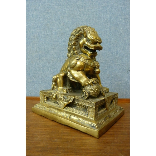 344 - A Chinese gilt bronze figure of a dog of foe