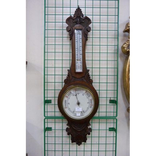 349 - An Edward VII carved oak aneroid banjo barometer