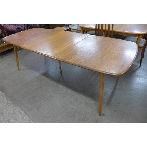 47 - An Ercol elm and beech extending Grand Windsor dining table