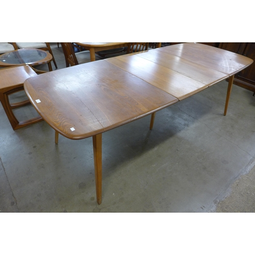 47 - An Ercol elm and beech extending Grand Windsor dining table