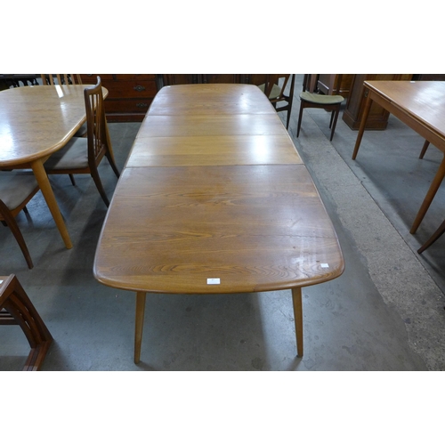 47 - An Ercol elm and beech extending Grand Windsor dining table