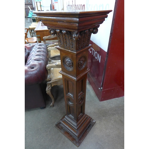 5 - A Victorian Gothic Revival carved mahogany pedestal