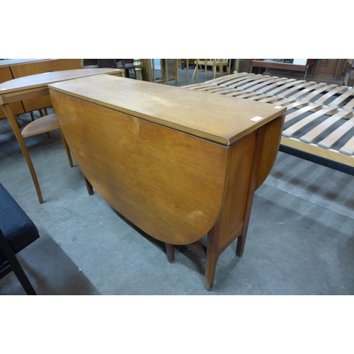 56 - A teak drop leaf table