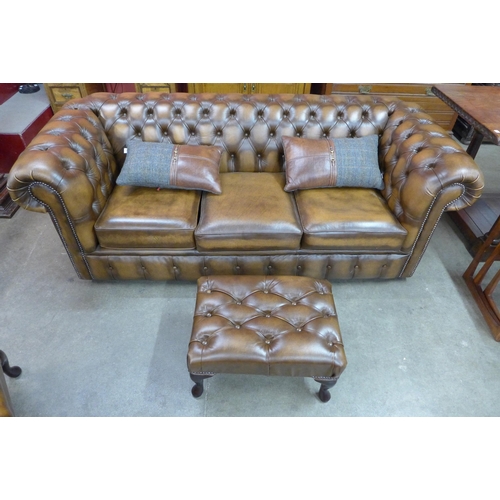 7 - A Chesterfield brown leather three piece lounge suite, comprising; sofabed settee, wingback armchair... 