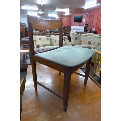 81 - A teak extending dining table and four chairs