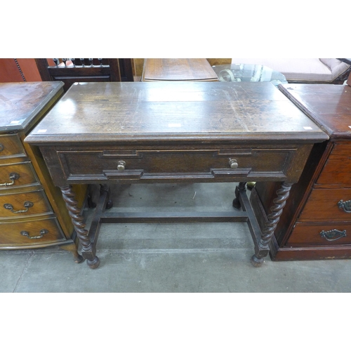 98 - An early 20th Century Jacobean Revival oak single drawer side table