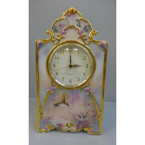 602 - A Bradford Exchange Garden Whispers Heirloom porcelain clock, 23cm