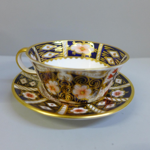 635 - Rpoyal Crown Derby; a Pre-release edition Imari goblet, 1128 Imari pin dish and an Imari cup and sau... 