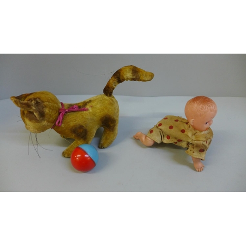 664 - A vintage clockwork kitten, one eye missing and clockwork baby toy