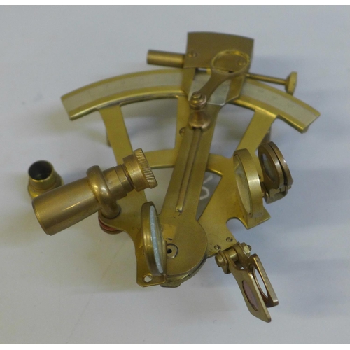 673 - A small brass sextant, one blue glass lens loose