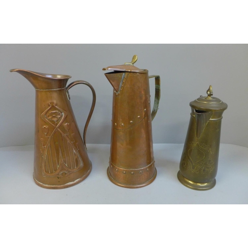 688 - Three Arts and Crafts/Art Nouveau jugs; two copper and one gilt brass