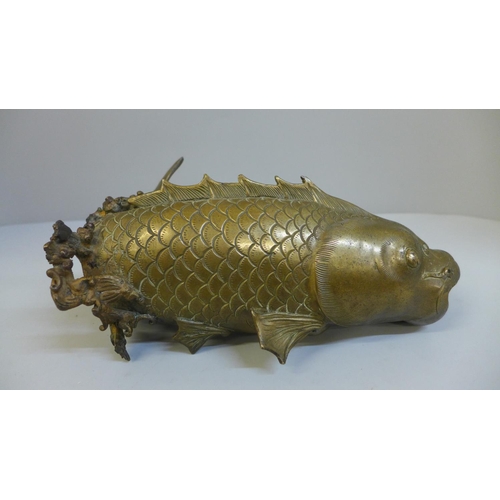 696 - A Japanese bronze leaping carp figure (some repairs needed at base, tail, etc.)