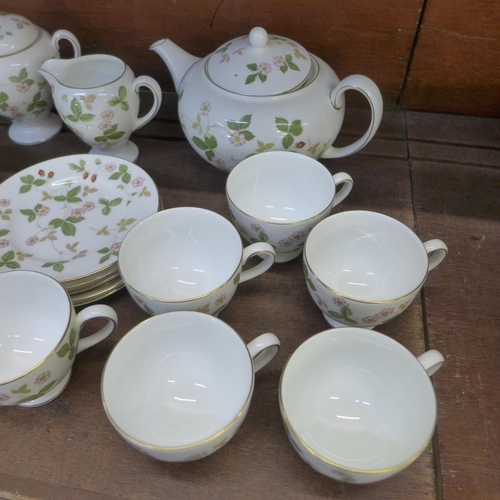 701 - A Wedgwood Wild Strawberry tea set, six settings with sugar pot and cream jug