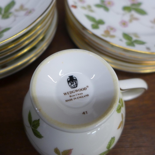 701 - A Wedgwood Wild Strawberry tea set, six settings with sugar pot and cream jug