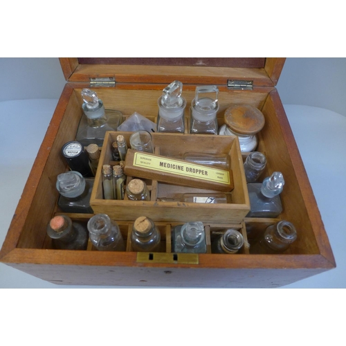 723 - A wooden apocathery box with bottles