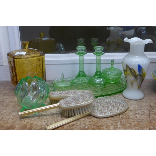 821 - A green glass dressing table set, an amber glass lidded jar and two glass vases