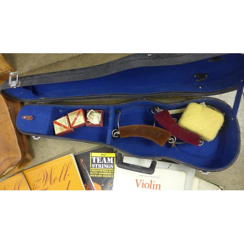 835 - A violin case and a collection of violin music and organ music in a leather satchel