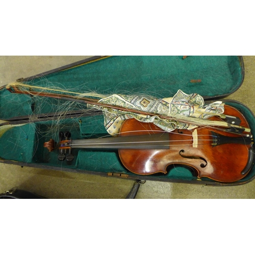 838 - Two violins; one Chinese, length of back 34cm and the other with no identifying label, length of bac... 