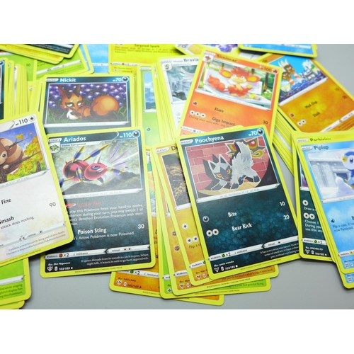 844 - Thirty Holo/reverse Holo and 300 common/uncommon/rare Pokemon cards in tin